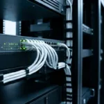 PoE switch for CCTV Dubai — managed network switch with camera cabling in a rack