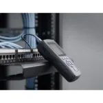 Cable certification testing — handheld field tester connected to a patch panel during commissioning